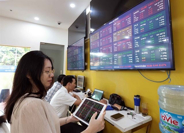 Investors tracking the market's movements on a trading floor